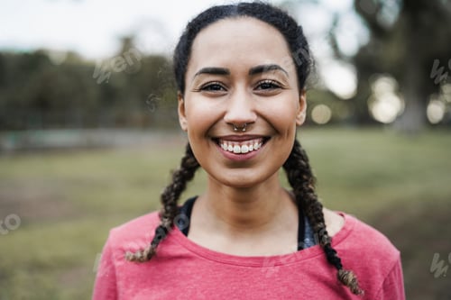 Preview: Multi ethnic girl smiling on camera outdoor in city park - Focus on face