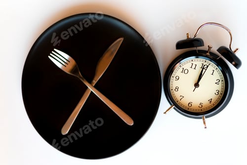 Preview: Time concept of dieting. Black alarm clock.