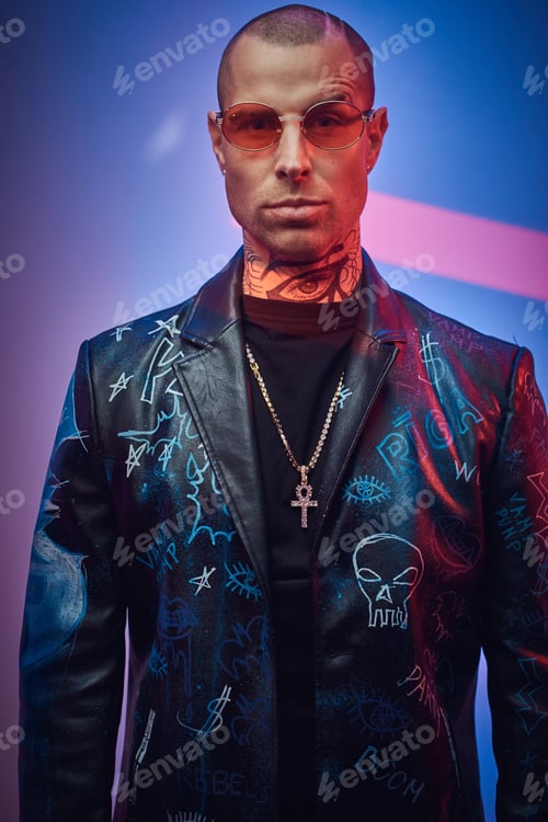 Preview: Rock styled serious guy posing in colored abstract background