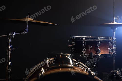 Preview: Drum kit in the dark with stage lighting, copy space.