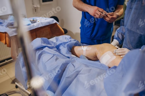 Preview: doctor and an assistant in the operating room for surgical venous vascular surgery clinic.