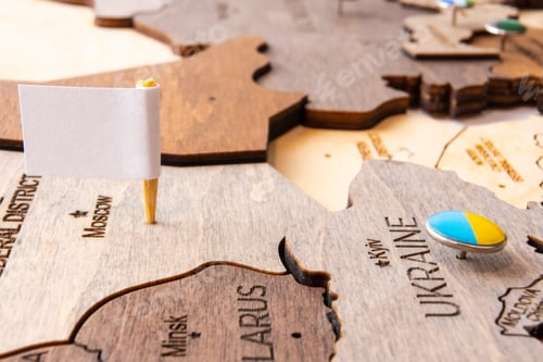 Preview: White flag on the wooden world map. Capitulation of Russia and Victory of Ukraine