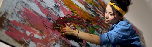 Preview: Focused young woman, female painter creating a large modern abstract oil painting, applying paint