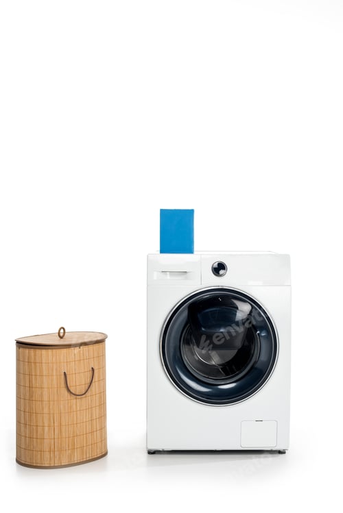 Preview: blank box with soap powder on washing machine and laundry basket isolated on white