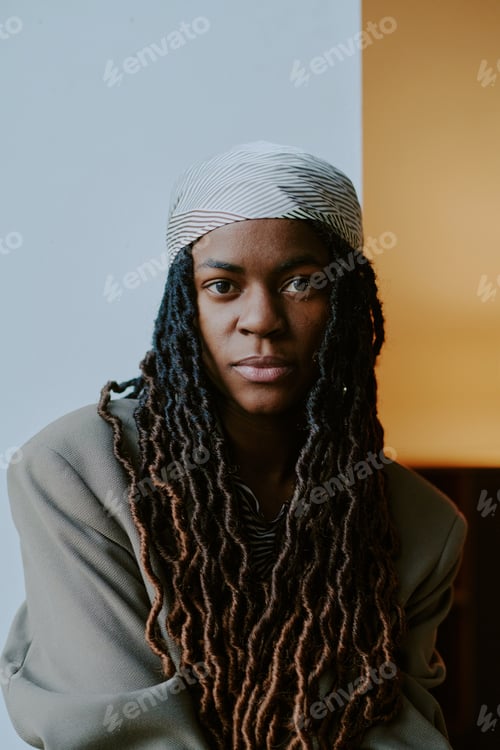 Preview: Portrait of Woman Wearing Headscarf Lighting Up