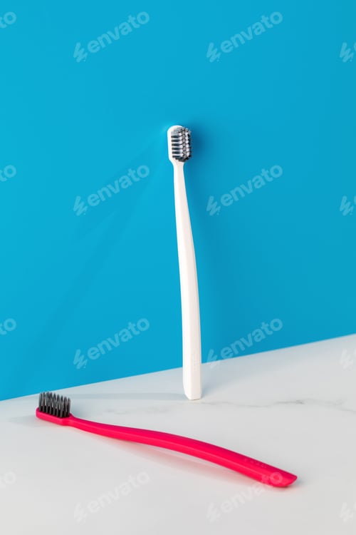 Preview: Couple of toothbrushes stands neatly on bathroom counter