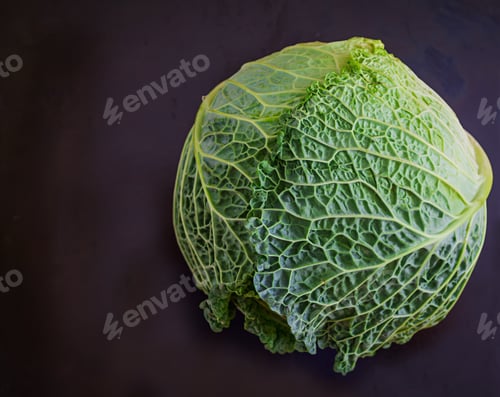 Preview: Savoy cabbage with pepper and greens on dark background