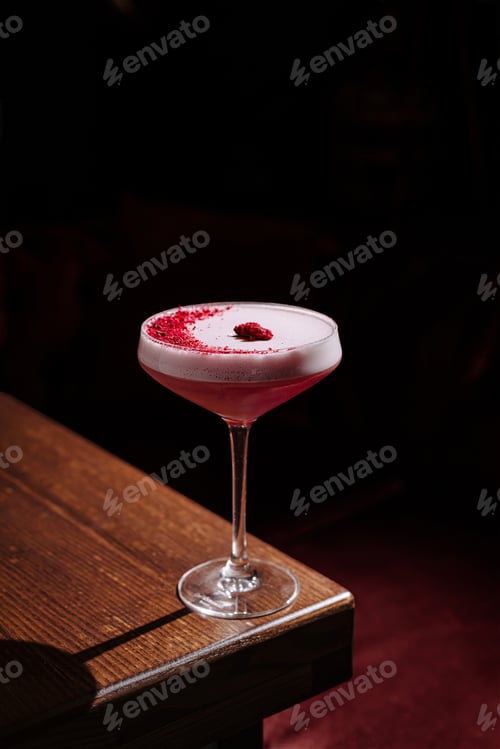 Preview: Sipping a vibrant raspberry cocktail in an ambient bar setting at night