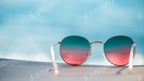 Preview: Colorful bright sunglasses on the background of the sea, concept summer vacation at the sea with