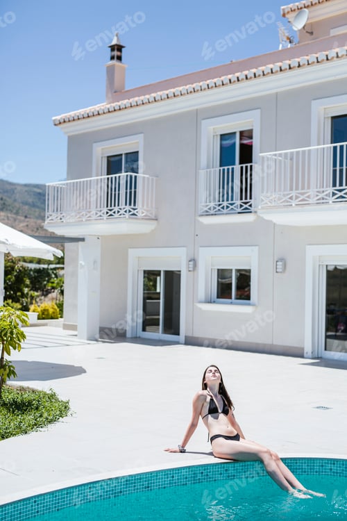 Preview: Young woman enjoying the summer time at pool