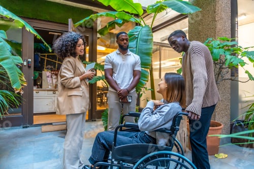 Preview: Disabled woman taking with coworkers colleagues outside the office