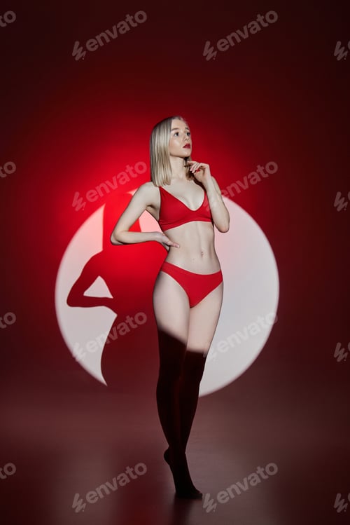 Preview: Young fashion woman in red lingerie underwear swimsuit light and shadow