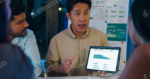 Preview: Group diverse Asia businesspeople talk ESG strategies risk management solar panel workshop night.