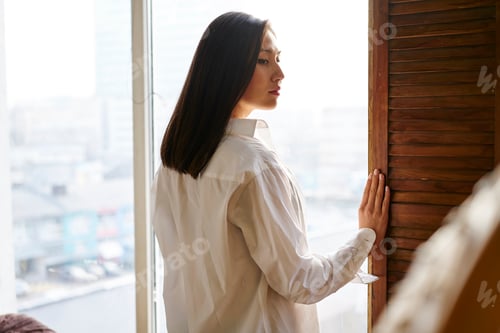 Preview: Thoughtful female feeling pondering during weekend leisure in home apartment or hotel room