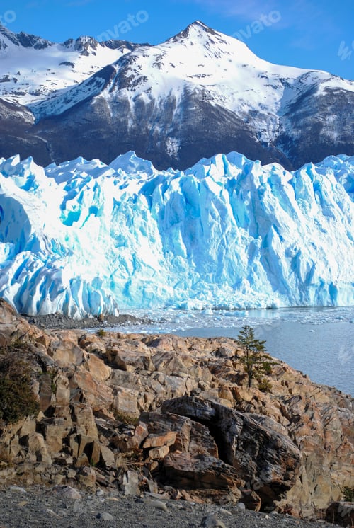 Preview: Glimmering blue ice of Perito Moreno glacier set against dramatic mountains