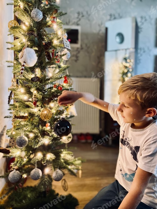 Preview: Child Decorating a Christmas Tree at Home