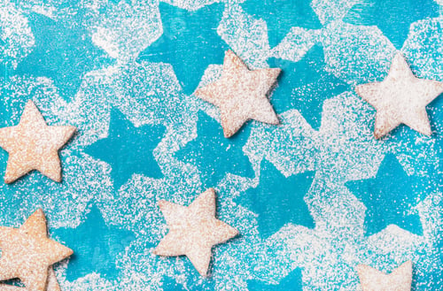 Preview: Heart shaped cookies with sugar powder over bright blue background