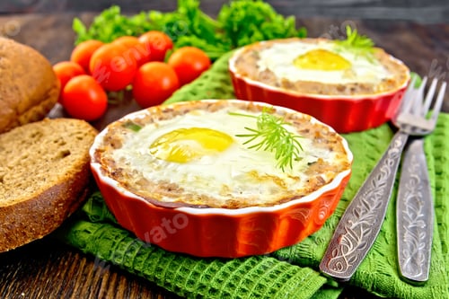 Preview: Tartlet meat with egg in pan on board