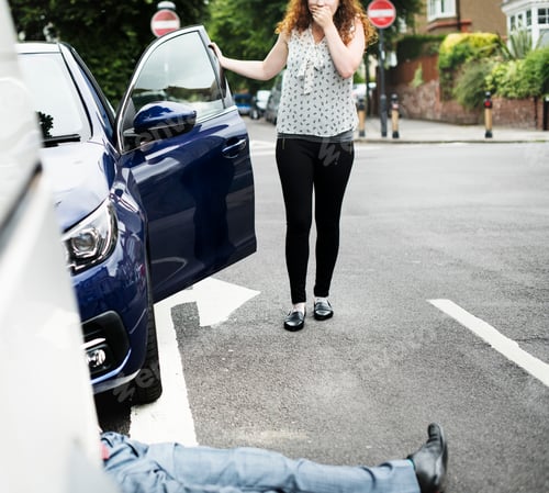 Preview: Person lying on the ground after a car accident
