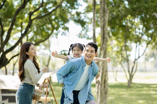 Preview: Asian family enjoying a picnic in the park on a sunny weekend.