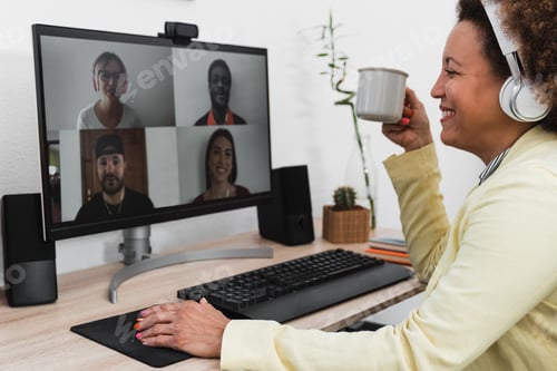 Preview: African business woman doing video call conference with colleagues using computer app at home