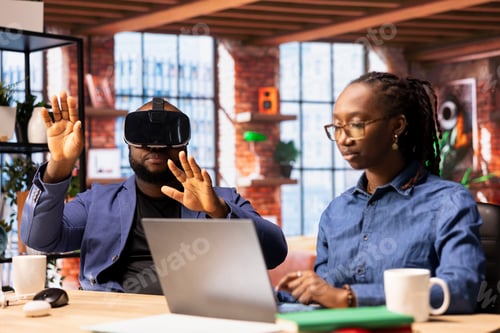 Preview: Black man embraces digital innovation at home office and uses VR headset