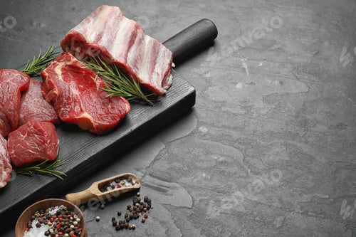 Preview: Composition with fresh raw meat on grey table. Space for text