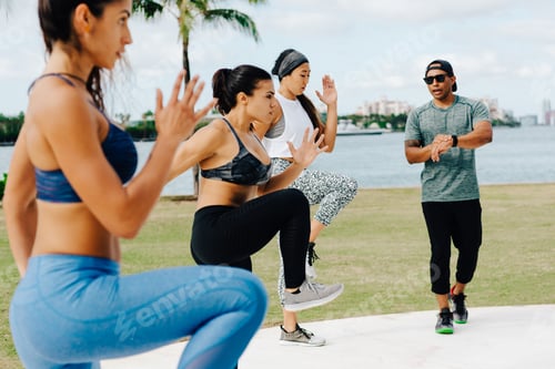 Preview: Three women working out with personal trainer, South Point Park, Miami Beach, Florida, USA