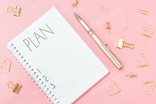 Preview: Inscription plan in blank notepad and stationery on pink background copy space.