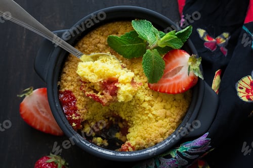 Preview: Homemade strawberry crumble on dark wooden background