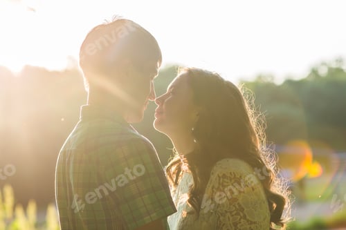 Preview: Closeup photo of romantic couple outdoors, side view.