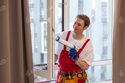 Preview: A repairman fixing windows in new apartment.