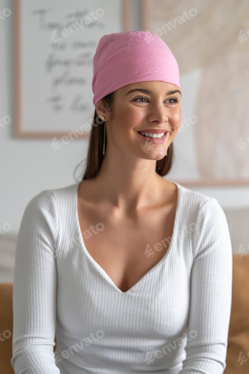 Preview: Frontal shot of smiling woman with pink veil on her head in protest for the fight against cancer