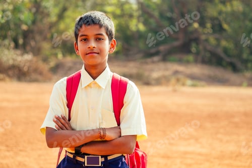 Preview: indian smart boy arms crossed looking at camera in backyard