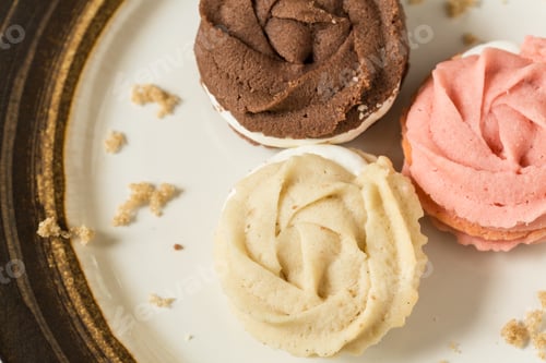 Preview: Close Up Of Vanilla Chocolate And Strawberry Cookies On Plate With Crumbs Of Brown Sugar