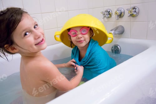 Preview: Girl having fun dressing up sister in bathtub
