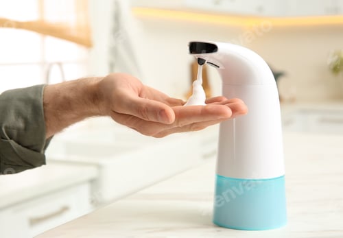 Preview: Man using automatic soap dispenser in kitchen, closeup