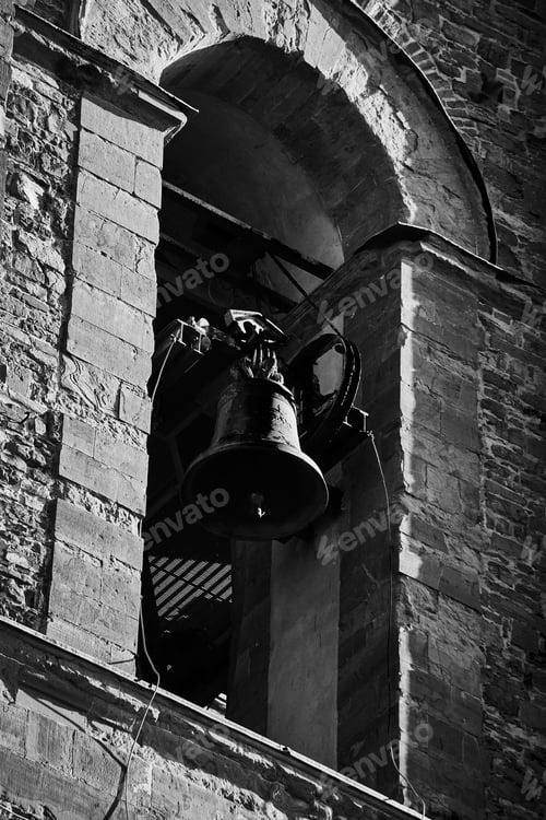 Preview: Grayscale of a large bell suspended on the wall of an outdoor structure