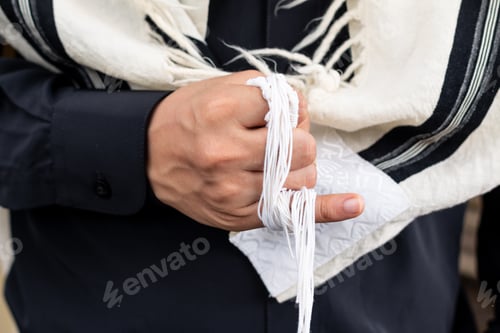 Preview: Tzitzit wrapped around a little finger to chant V'zot Hatorah. This is the Torah.