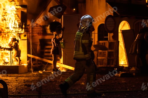 Preview: Firefighter protective suit working controlling the burning of a Falla during the Valencian