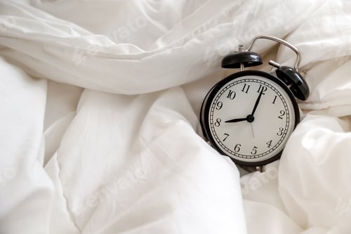 Preview: Classic alarm clock in bed, concept of morning routine