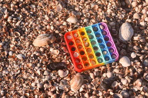 Preview: rainbow Pop it toy to play on vacation at the sea.
