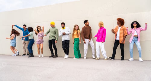 Preview: Happy playful multiethnic group of young friends bonding outdoors