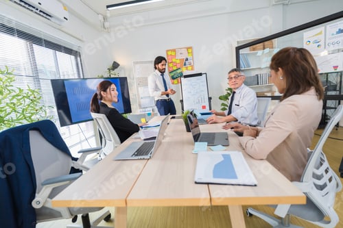 Preview: Business Professionals Discussing Project in Modern Office