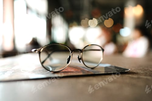 Preview: Stylish Round Glasses Resting on Table in Cafe