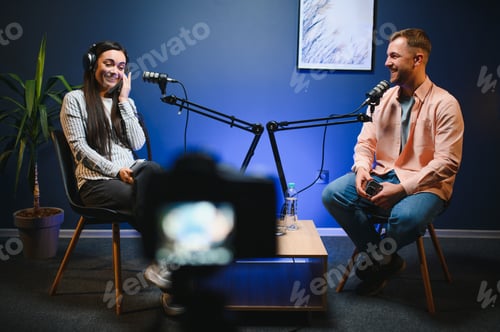 Preview: woman hosting podcast interviewing man while recording with professional microphones