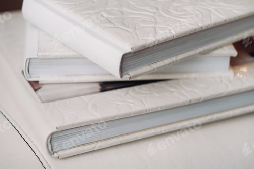 Preview: Composition of photobooks in natural brown leather . Fragment of a photobook binding