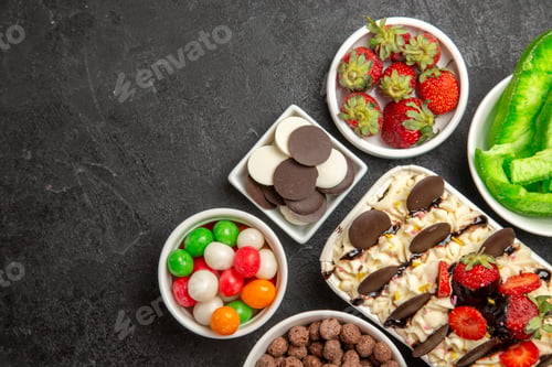 Preview: top view delicious dessert with candies cookies and strawberries on the dark background nut biscuit
