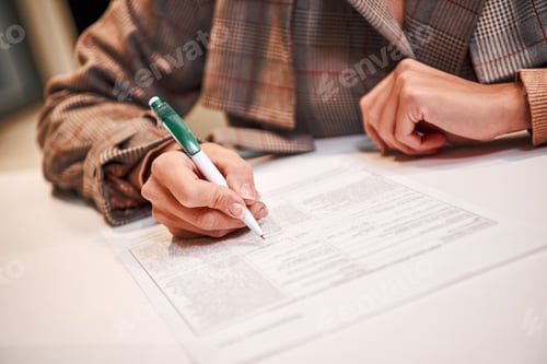 Preview: Filling Out Paperwork with Pen on Desk