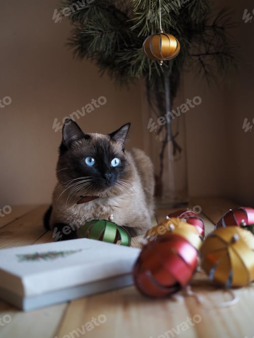 Preview: Colourful handmade paper origami balls, gift box with embroidered Christmas tree on a wooden table.